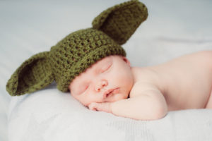 Cute newborn baby boy asleep with hat on