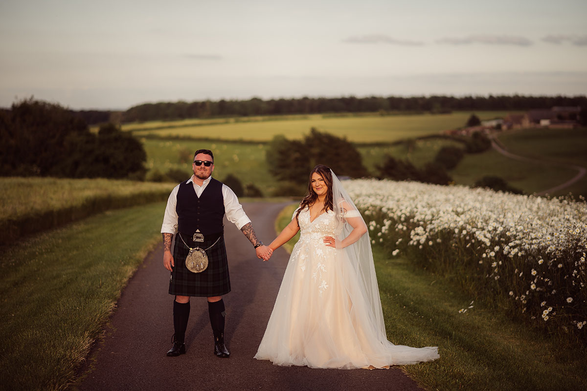 Bride & Groom in the sunshine at Kingscote Barn