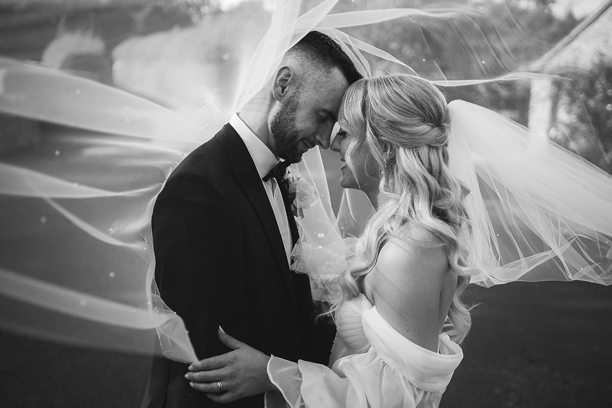 Bride and groom under a veil