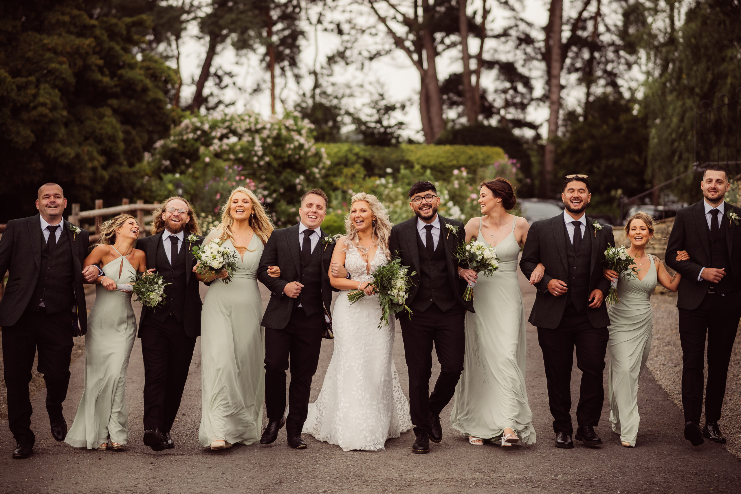 Bridal party all walking together arm in arm