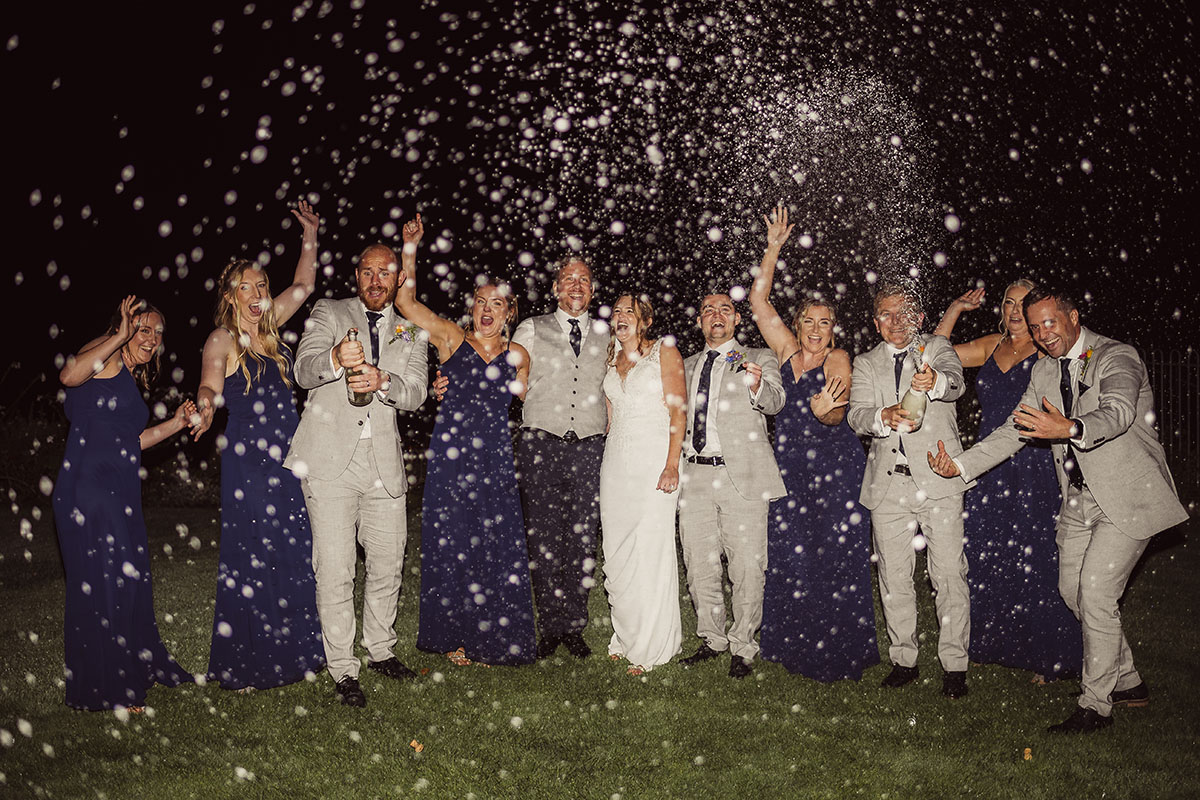 Bride & Groom spraying champagne